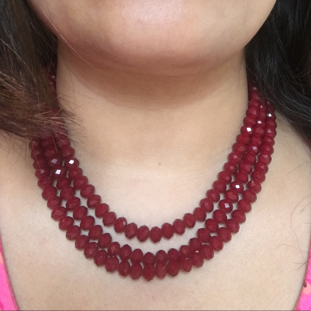 Red beaded multi strand necklace.